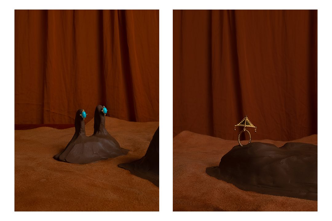 Turquoise pieces on sculpted clay, and a gold ring on a clay mound, before a rust curtain