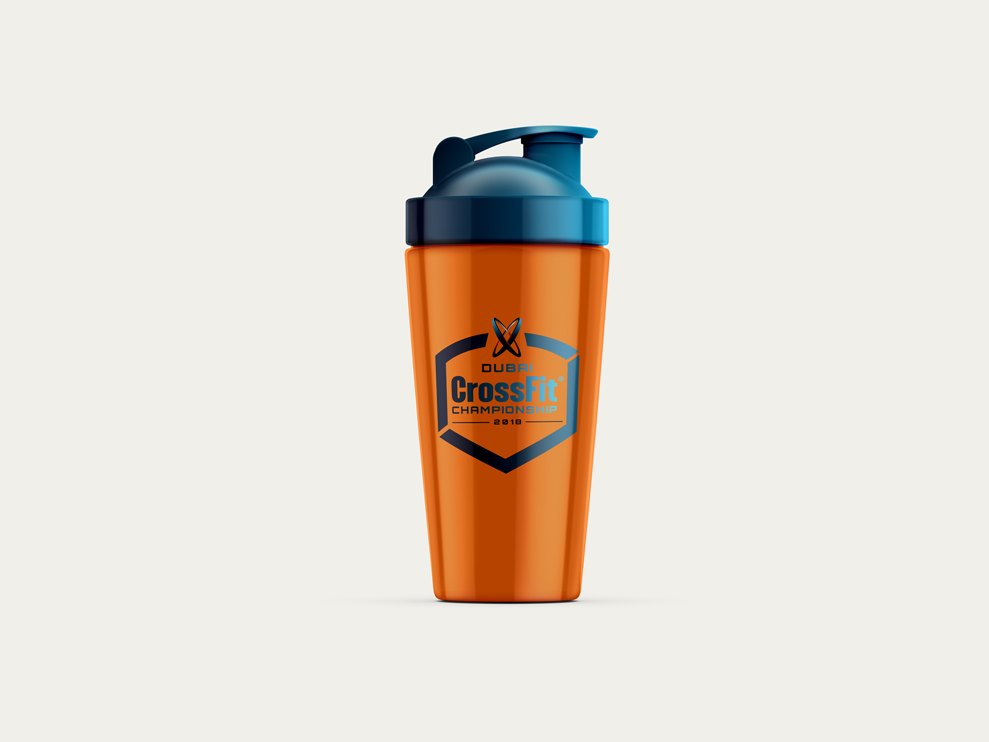 An orange protein shaker with a navy lid, the badge printed on the side