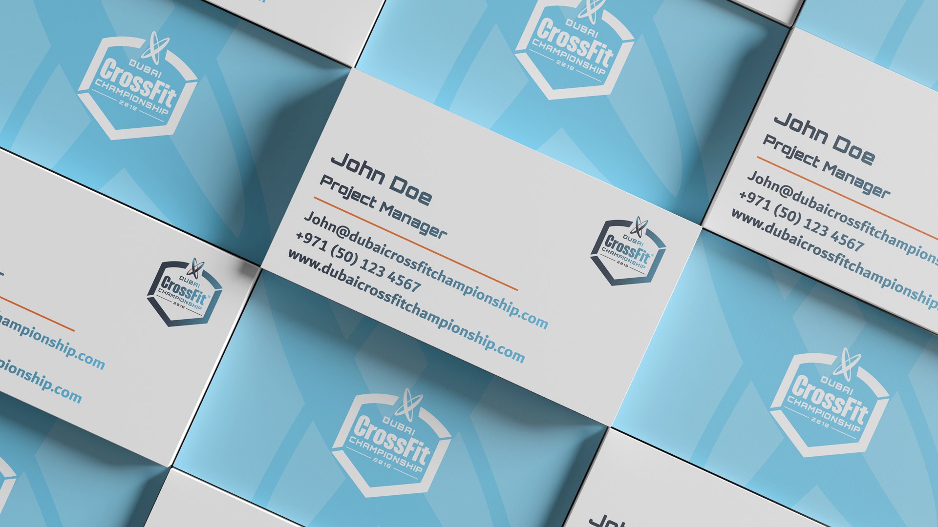 Business cards laid in a field, white fronts and blue backs with the mark in tone