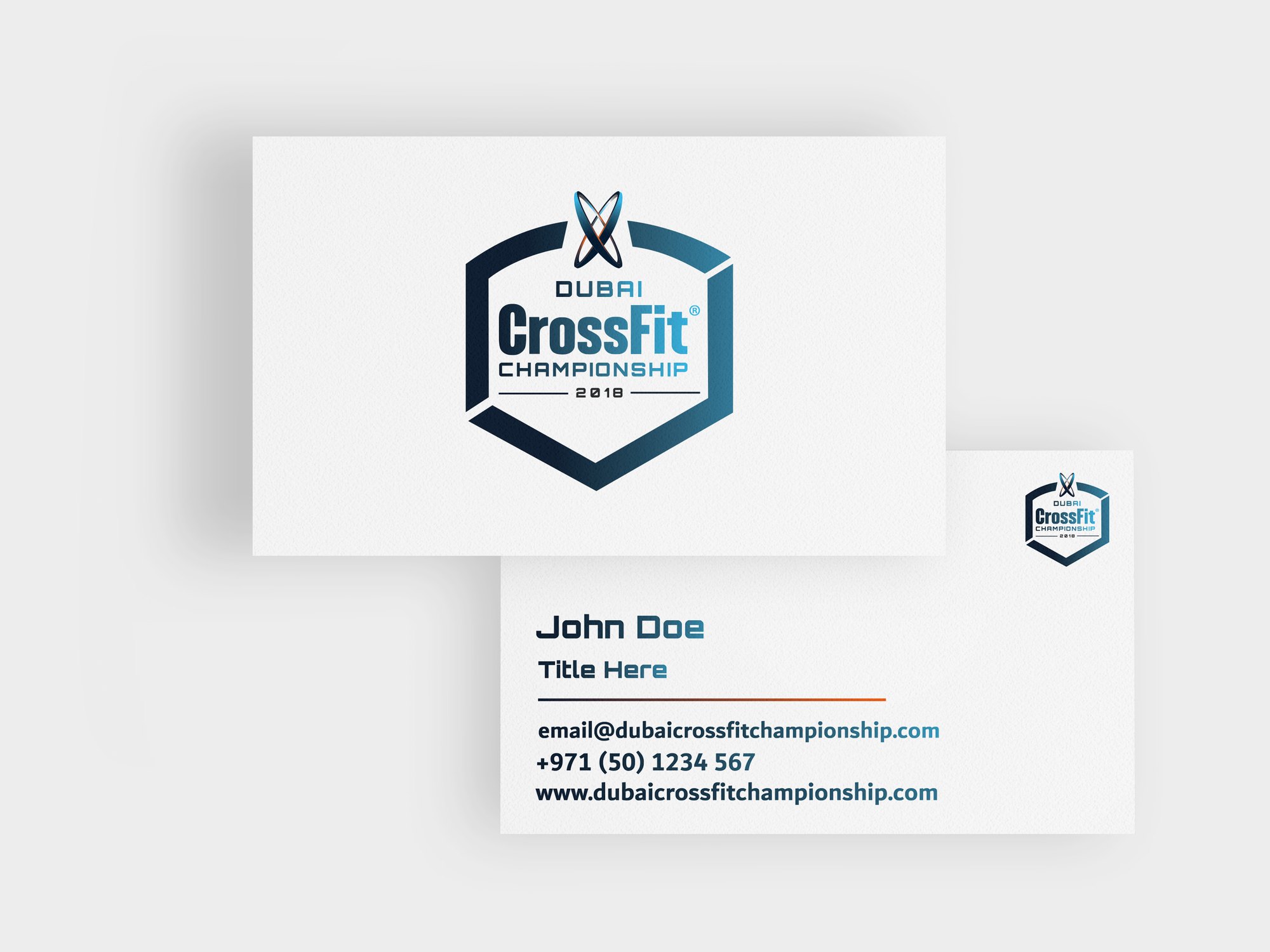 A white business card with the full-colour badge, a second card with name and contact lines