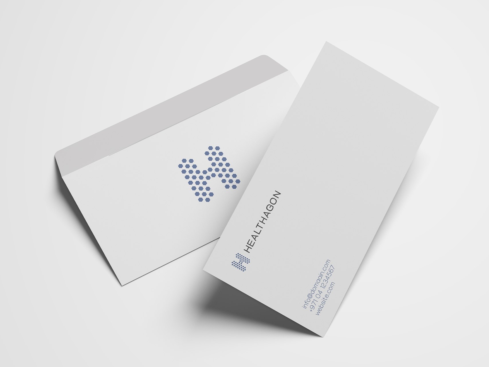 A white envelope with a large blue hexagon H beside a card with the logo