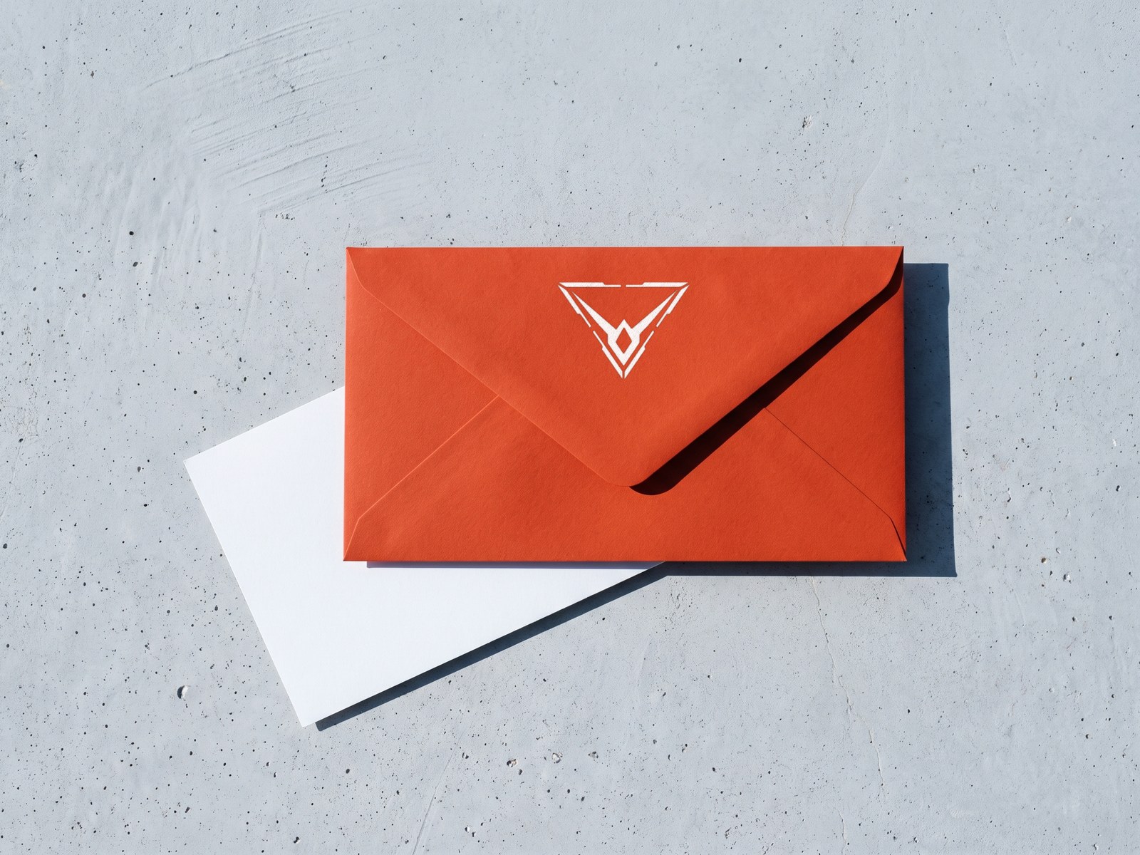 A render of an orange envelope, back up, the Hypereon mark in white on its flap, over a white card on concrete