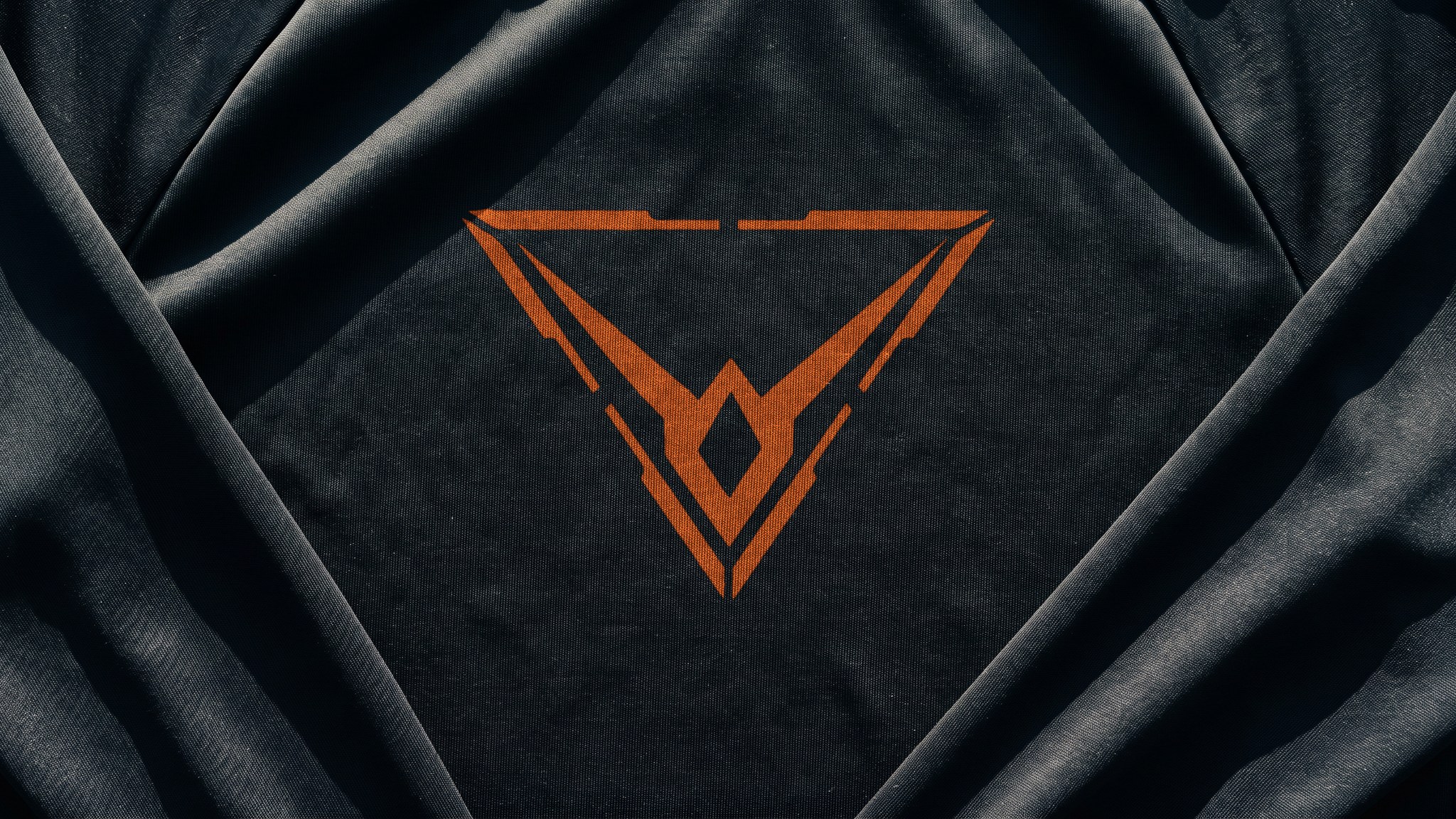 A render of black training jersey in raking sun, the orange Hypereon mark printed large across the chest