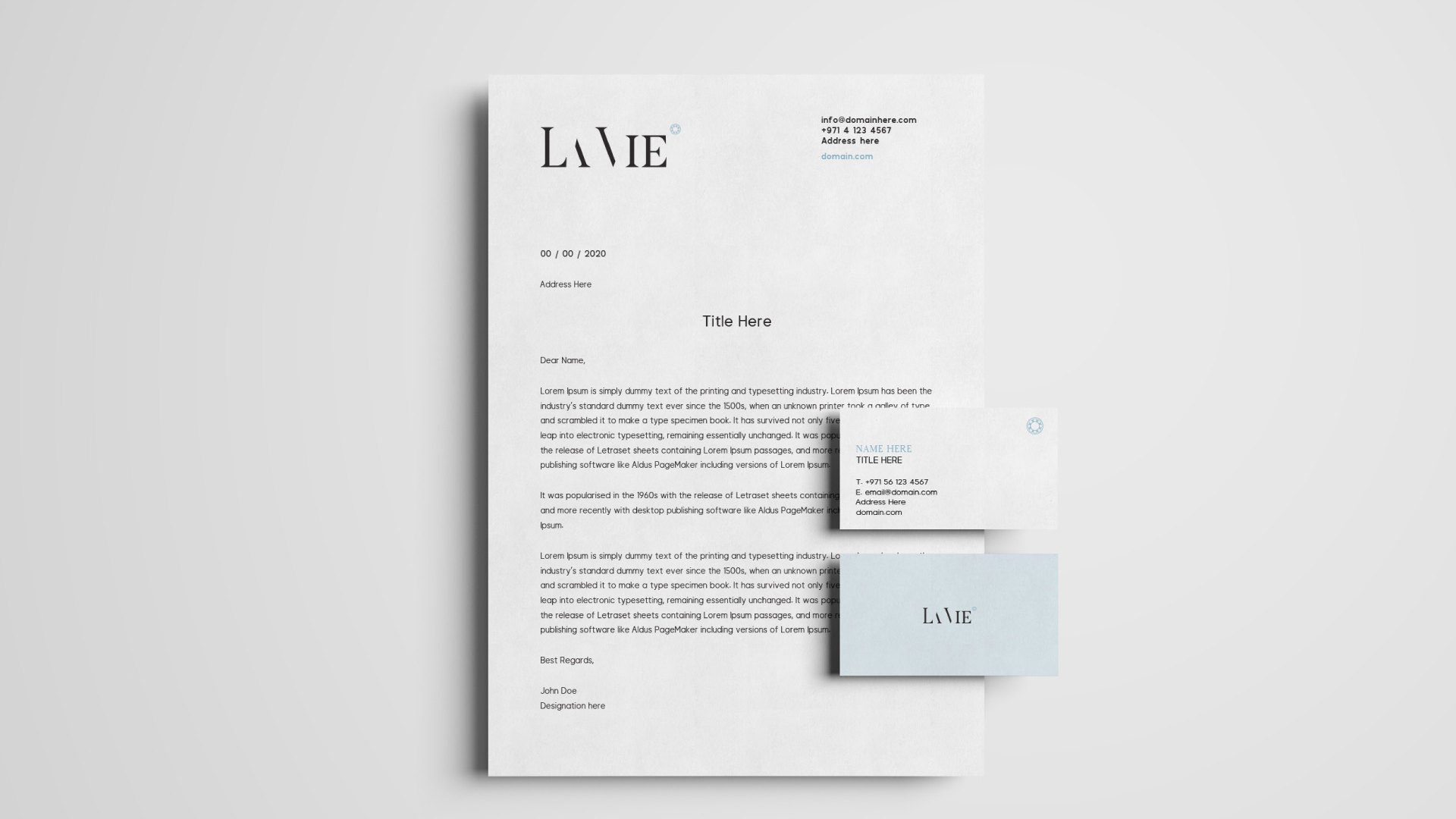 A La Vie letterhead with two business cards on grey