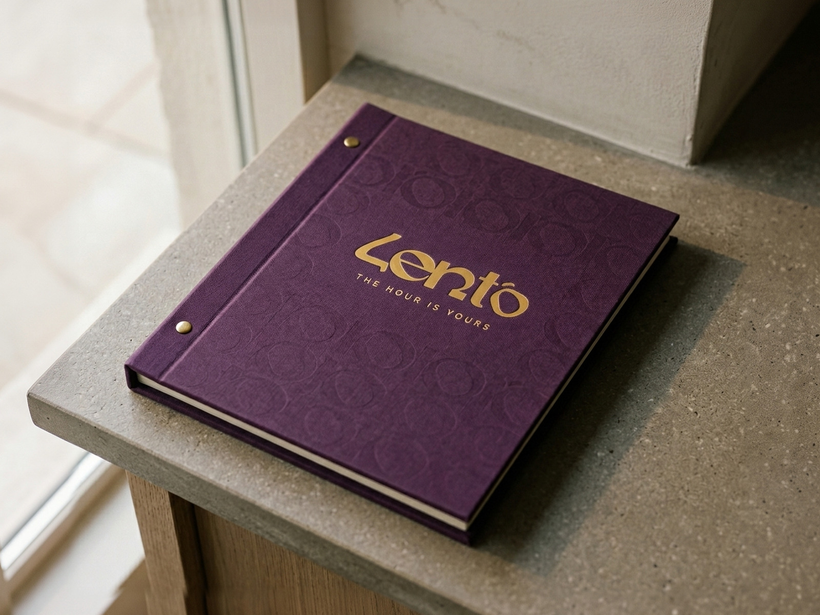 The Lento menu cover in plum cloth with the mustard lockup