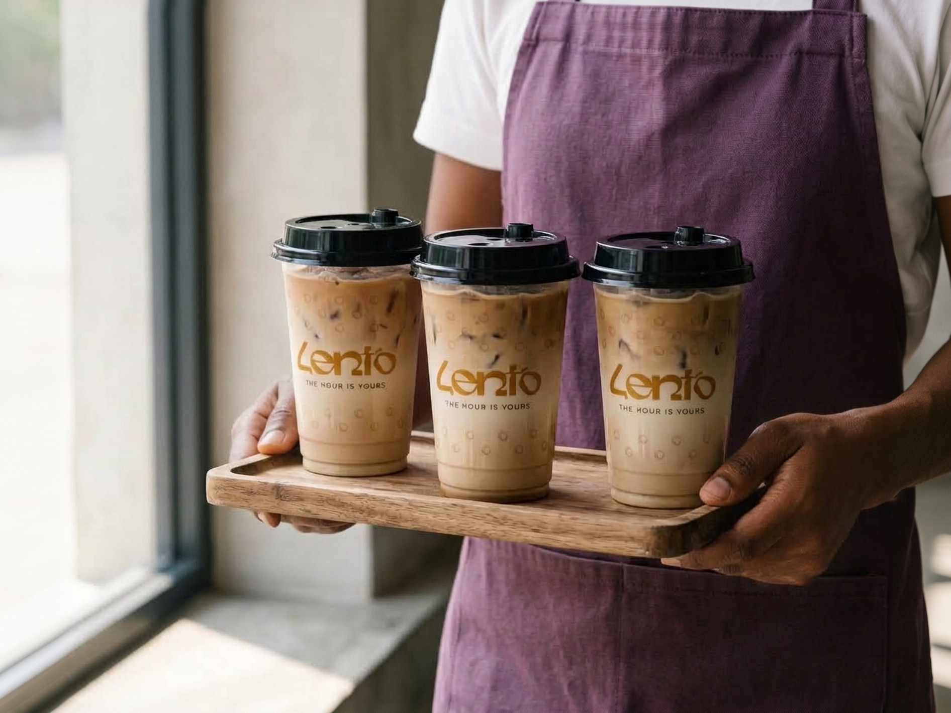 Three Lento iced coffees carried on a wooden board