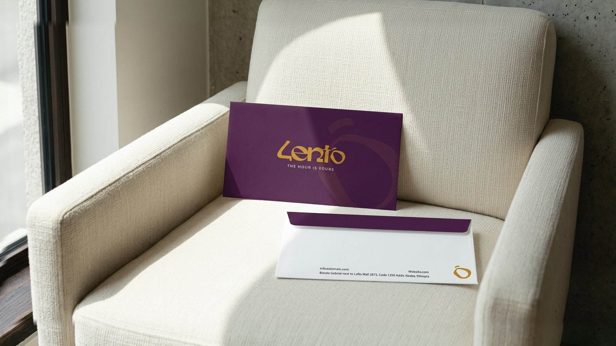 A plum Lento envelope and a cream card on a linen chair