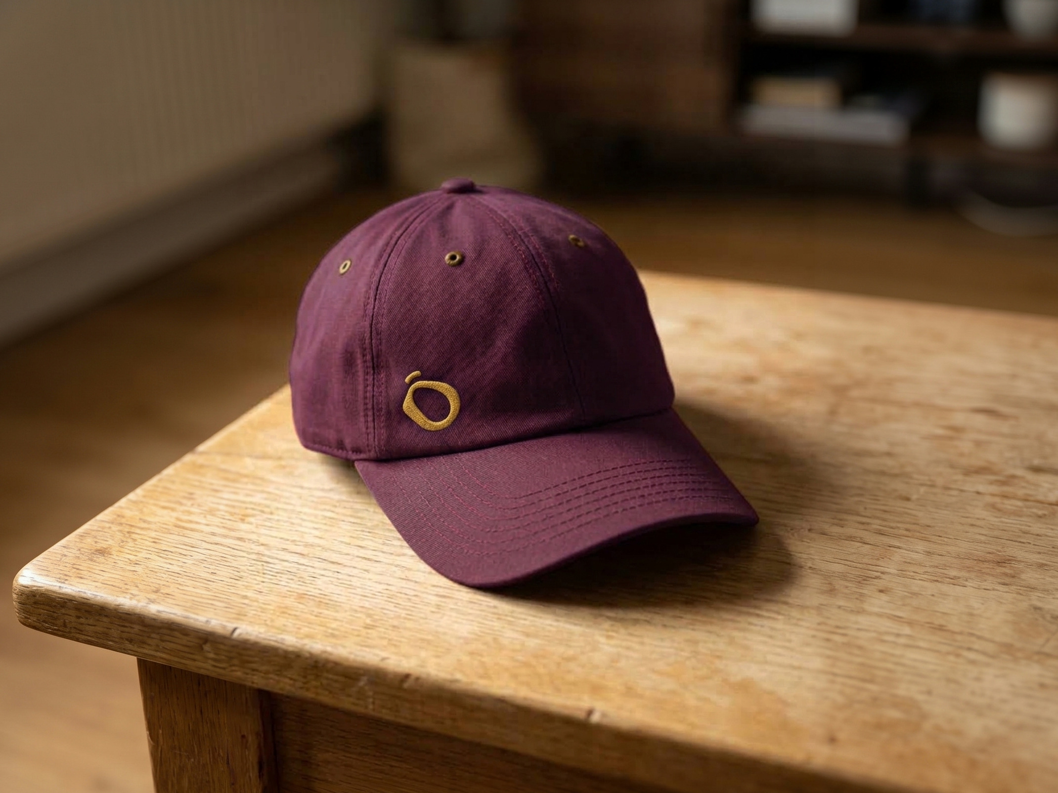 The plum Lento cap with the icon stitched in mustard