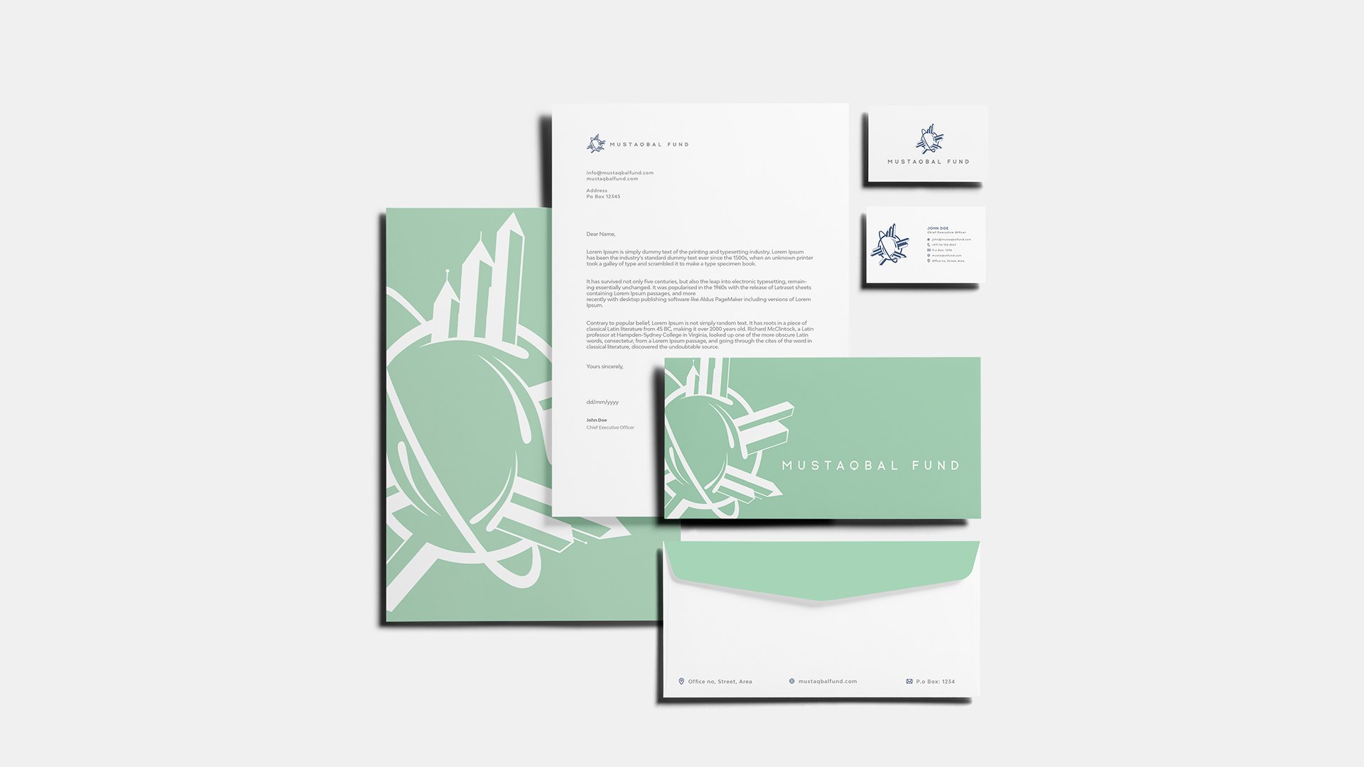 A stationery set on pale grey: a mint folder, letterhead, cards, slip, envelope