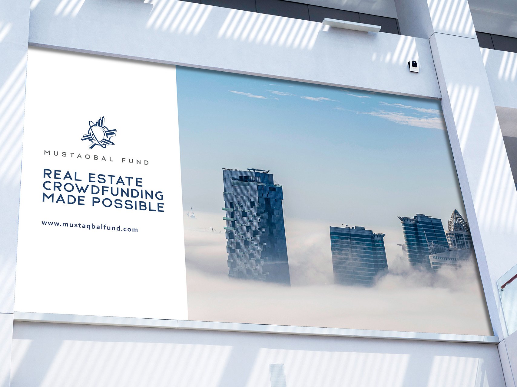 A mall billboard: the logo and the fund's line beside towers above fog