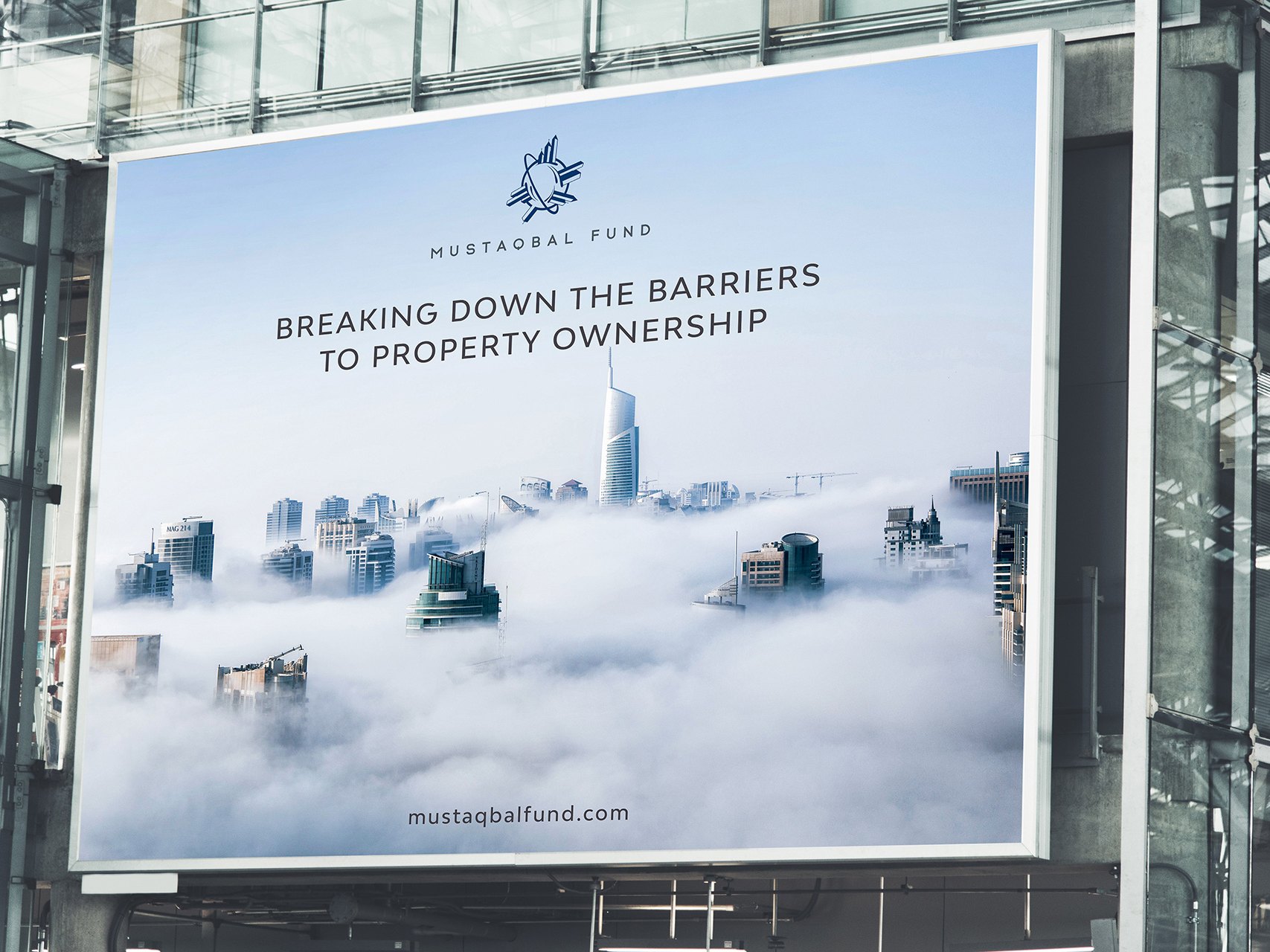 A billboard on a glass building: the logo and line over towers in fog