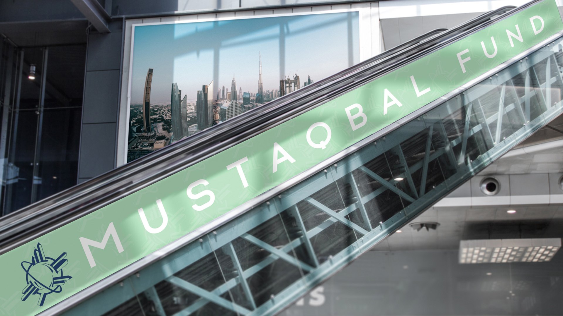 A mint banner along a mall escalator reading Mustaqbal Fund