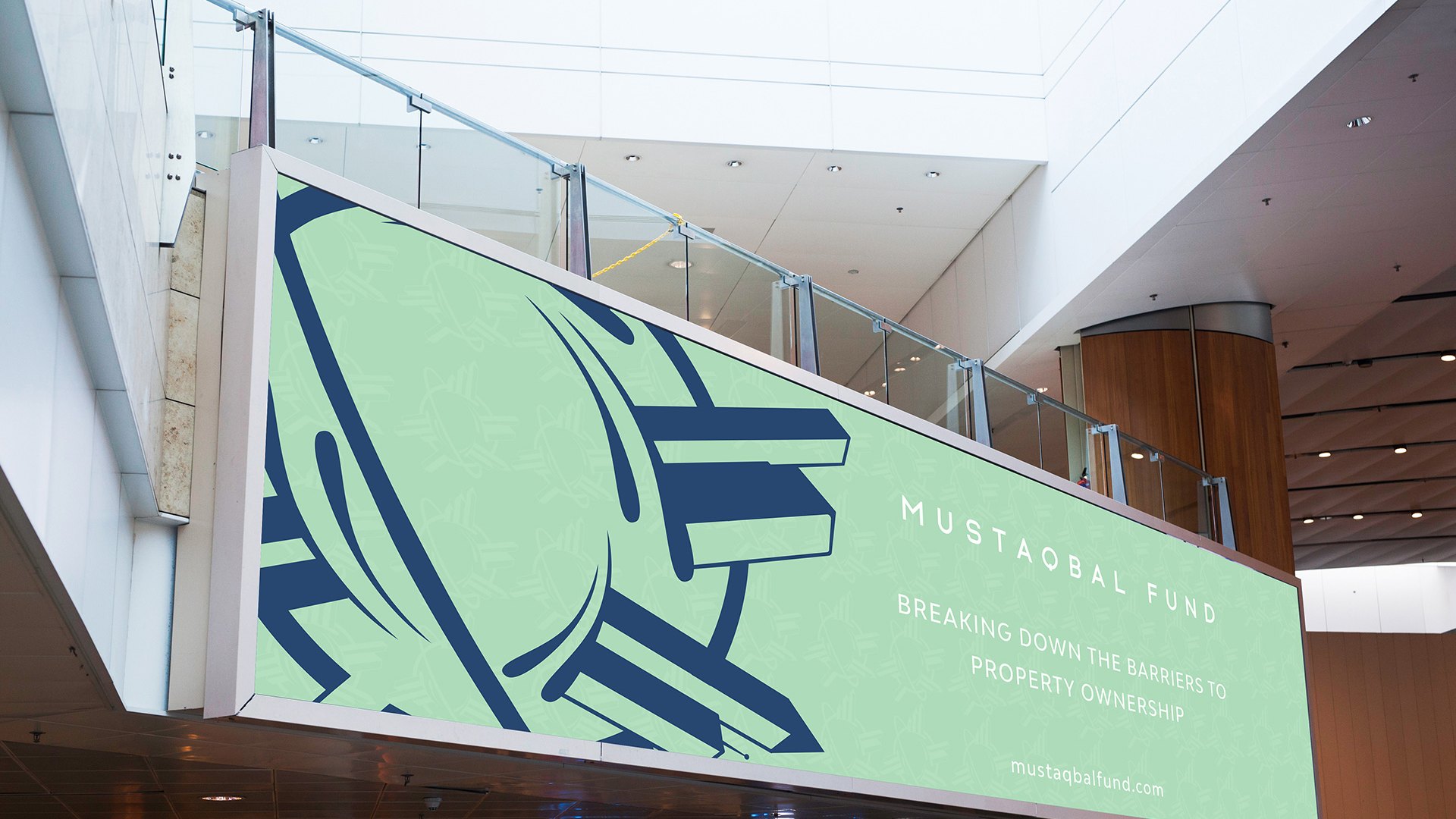 A mint banner in a mall atrium, the navy mark very large and cropped