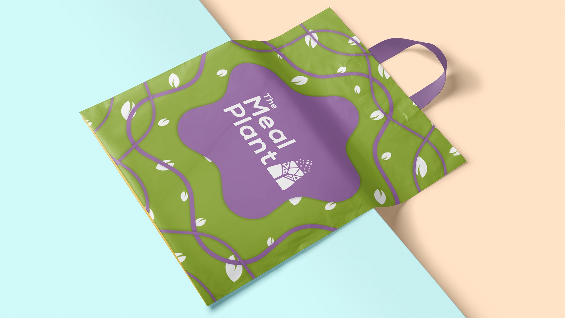 A green carrier bag with a lilac handle and a lilac star with the logo