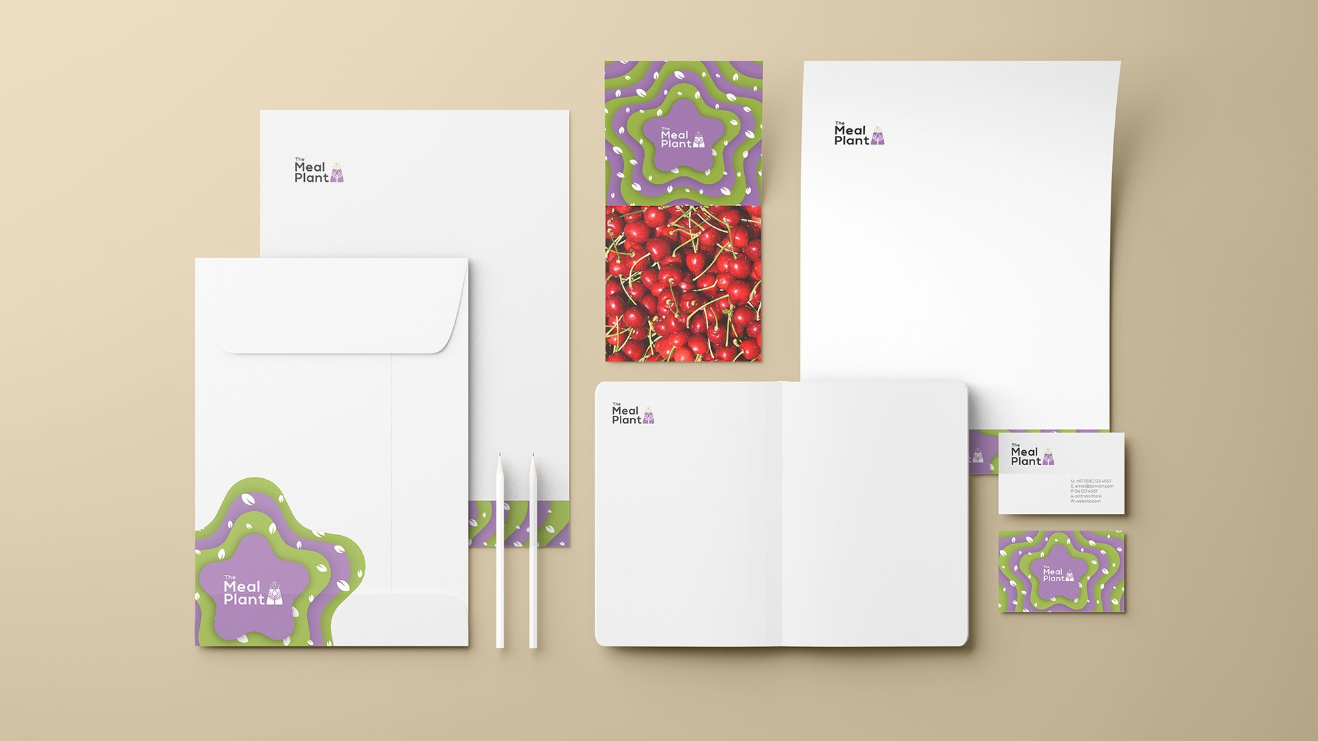 A stationery set on sand: letterheads, envelope, card, notebook and cards